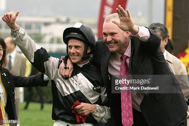 Jockey Brett Prebble and trainer of Absolute Champion David Hall celebrate after winning the Cathay Pacific Hong Kong Sprint during the Cathay...