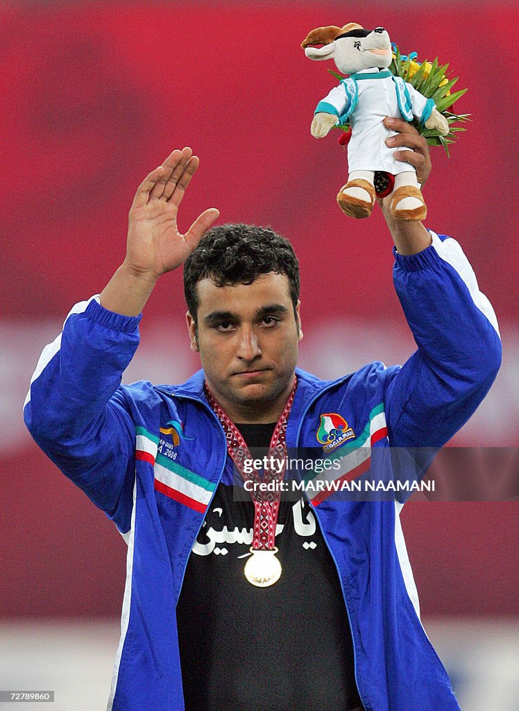 Iran's Ehsan Hadadi waves at the awards