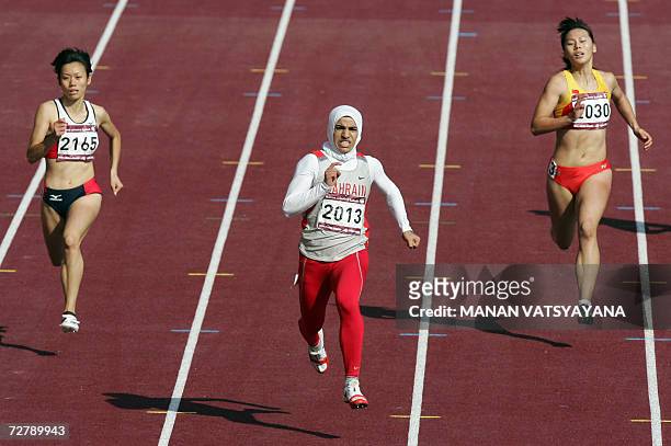 Bahrain's Ruqaya Al Ghasara runs ahead of Japan's Takarako Nakamura and China's Chen Jue in the women's 200m heat 3 event on the third day of the...