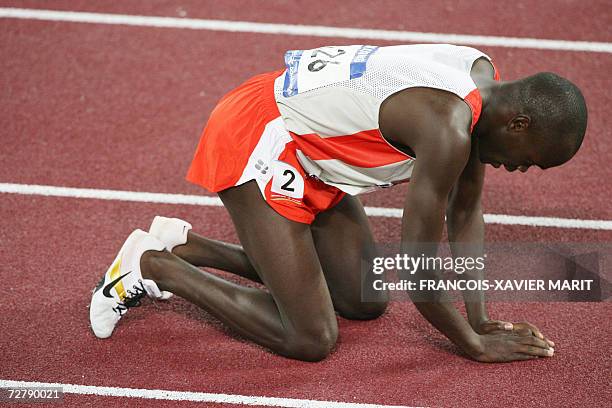 Bahrain's Belall Mansoor Belal kneels on the track after losing in the men's 1500m final by 0.02 sec, on the third day of the athletics competition...