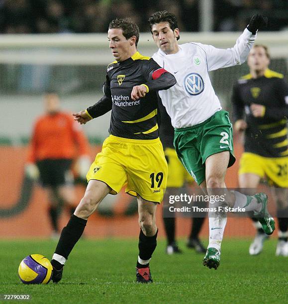 Jan Schlaudraff of Aachen and Facundo Quiroga of Wolfsburg in action during the Bundesliga match between VFL Wolfsburg and Alemannia Aachen at the...