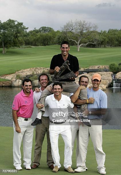 Alvaro Quiros of Spain is lifted up high with the trophy by fellow Spanish players after winning The Dunhill Championships on a score of 275 at The...
