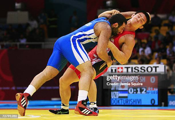 Alexandr Dokturishivili of Uzbekistan competes with Shingo Matsumoto of Japan in the Men's Greco-Roman Wrestling 84kg bronze medal match B during the...