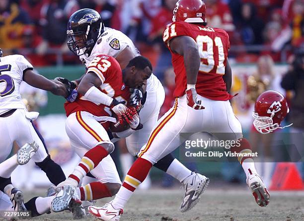 Patrick Surtain of the Kansas City Chiefs is tackled by Jason Brown of the Baltimore Ravens after intercepting the football at Arrowhead Stadium...