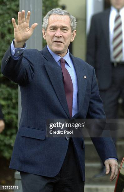 President George W. Bush waves as he leaves a Sunday morning service at St. John's Episcopal Church December 10, 2006 in Washington, DC.