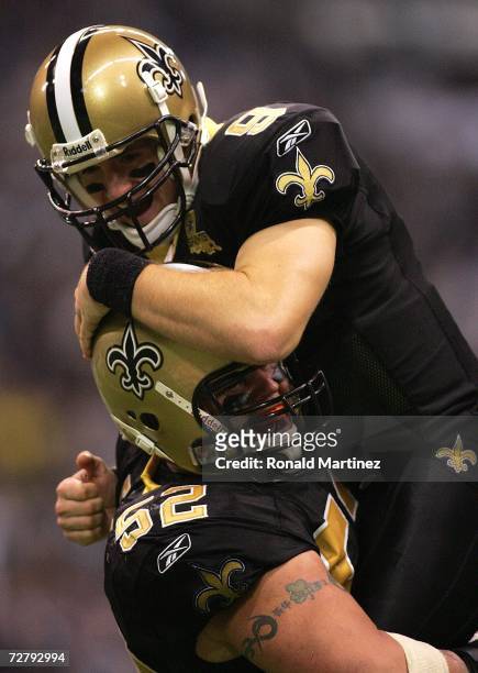 Quarterback Drew Brees of the New Orleans Saints celebrates a touchdown with Jeff Faine during play against the Dallas Cowboys in the third quarter...