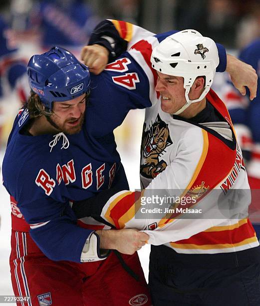 Ryan Hollweg of the New York Rangers takes a punch from Steve Montador of the Florida Panthers during their second period fight on December 10, 2006...