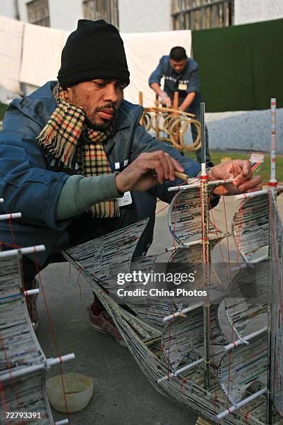 An foreign inmate makes a sailboat model as preparation for Christmas at the Shanghai Qingpu Prison on December 10, 2006 in Shanghai, China. As the...