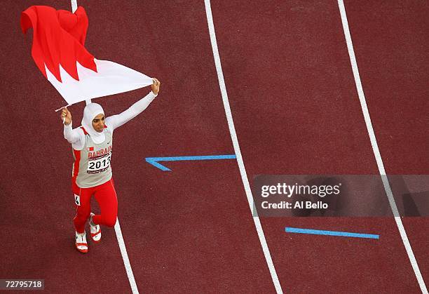 Ruqaya Al Ghasara of Bahrain celebrates winning the Women's 200m during the 15th Asian Games Doha 2006 at the Khalifa Stadium December 11, 2006 in...