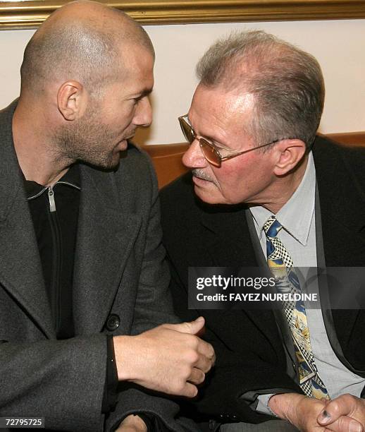 French football star Zinedine Zidane chats with his father after his arrival at Houari Boumediene international airport in Algiers City 11 December...