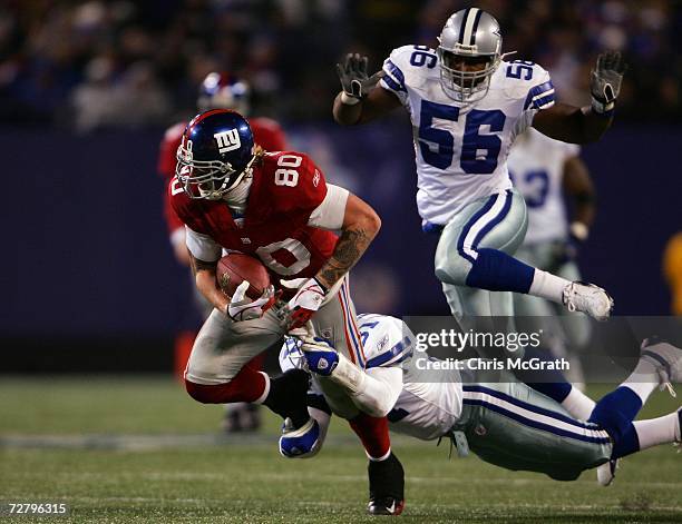 Jeremy Shockey of the New York Giants is tackled by Roy Williams of the Dallas Cowboys at Giants Stadium on December 3, 2006 in East Rutherford, New...