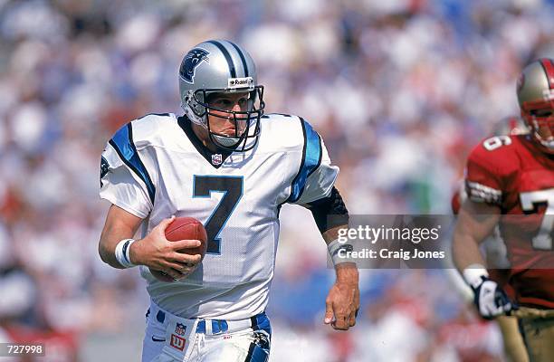 Quarterback Steve Beuerlein of the Carolina Panthers scrambles with the ball during the game against the San Francisco 49ers at Ericsson Stadium in...