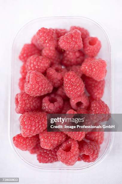 raspberries in plastic punnet - fruit carton stock pictures, royalty-free photos & images