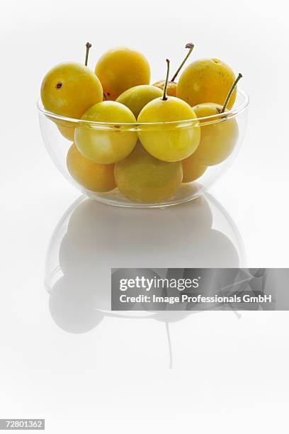 mirabelles in glass bowl - mirabelle plum stock pictures, royalty-free photos & images