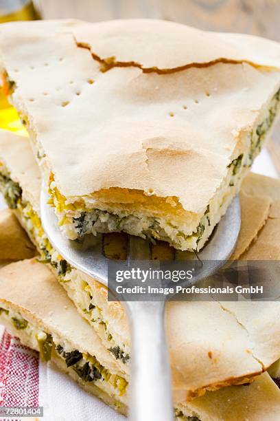 spinach and ricotta pie (one piece on spatula) - mushroom pie stock pictures, royalty-free photos & images