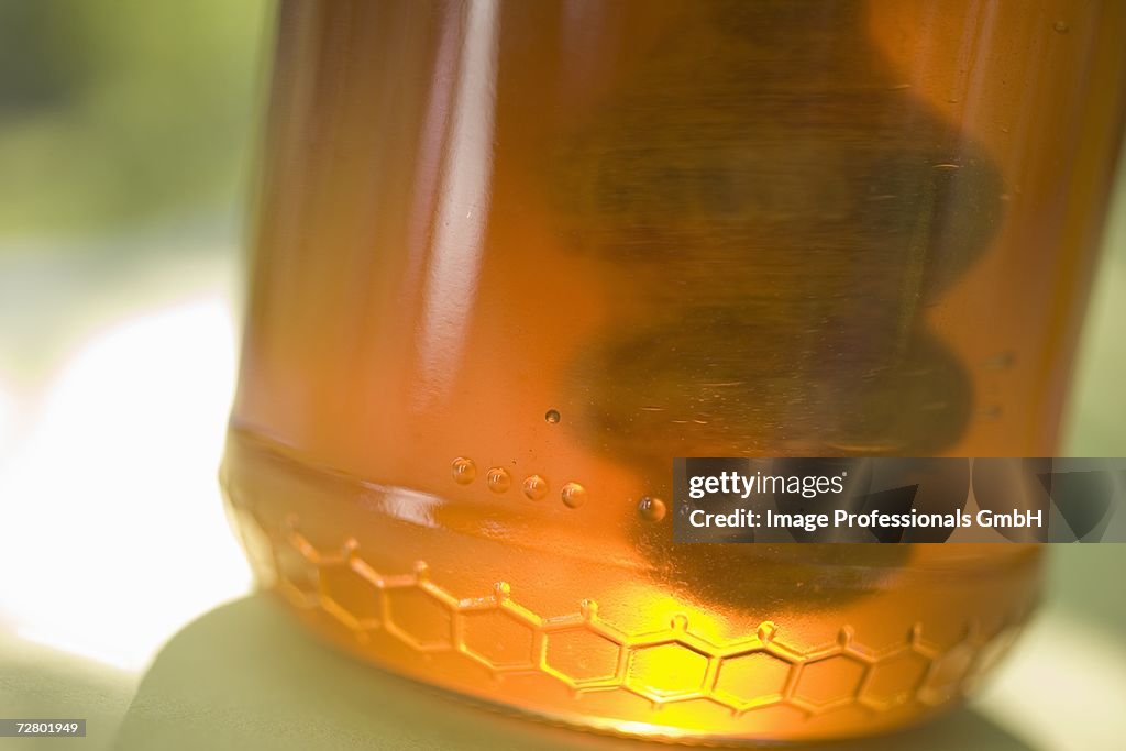 Jar of honey with honey dipper