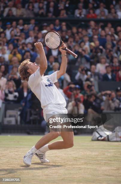 Swedish tennis player Stefan Edberg celebrates winning the Gentlemen's Singles Challenge Cup Trophy after defeating Boris Becker, 4-6, 7-6, 6-4, 6-2...