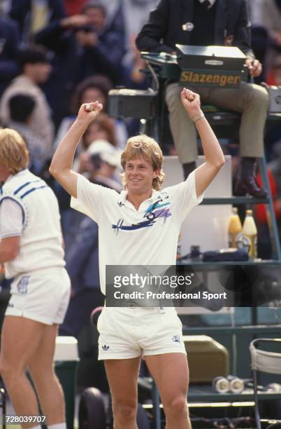 Swedish tennis player Stefan Edberg raises his arms in the air in celebration upon winning the Gentlemen's Singles Challenge Cup Trophy after...