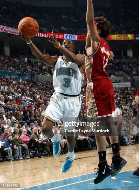 Chris Paul of the New Orleans/Oklahoma City Hornets shoots a layup against Anderson Varejao of the Cleveland Cavaliers December 11, 2006 at the Ford...