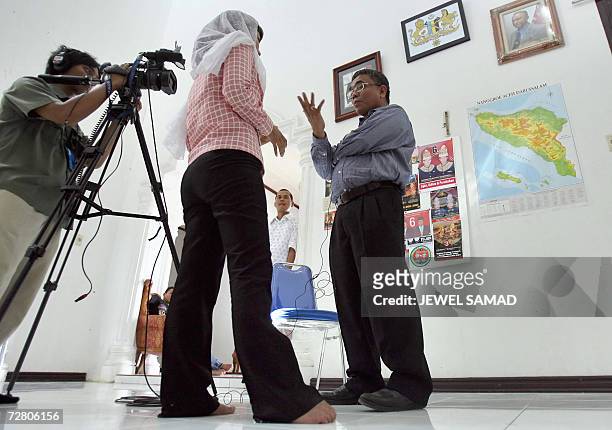 Banda Aceh, INDONESIA: Irwandi Yusuf, the former spokesman of the Free Aceh Movement and a front running Governor candidate, gesture as he is being...