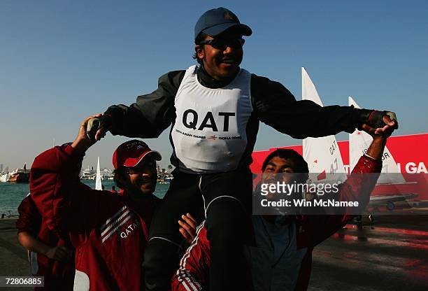 Waleed Al Sharshani of Qatar celebrates winning the silver medal after the Laser 4.7 Open Race during the 15th Asian Games Doha 2006 at the Doha...