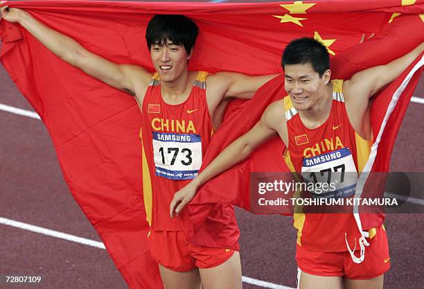 China's Liu Xiang celebrates with compatriot Shi Dongpeng after their one-two finish in the men's 110m hurdles final on the fifth and final day of...