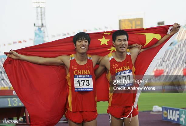 Liu Xiang of China celebrates with Shi Dongpeng of China after Liu won the Men's 110m Hurdles final during the 15th Asian Games Doha 2006 at the...