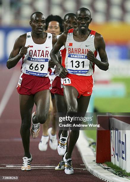 James Kwalia C Kurui of Qatar and Mucheru Salem Jawher of Bahrain compete in the Men's 5000m final during the 15th Asian Games Doha 2006 at the...