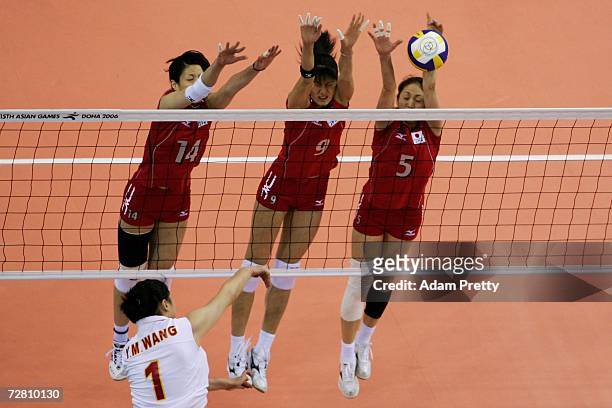 Shuka Oyama , Sachiko Sugiyama and Miyuki Takahashi of Japan attempt to block Wang Yimei of China in the Women's Gold medal match between China and...