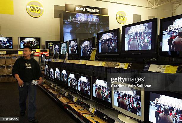 Customer shops for televisions at a Best Buy store December 12, 2006 in San Francisco. Best Buy Co. Reported that third-quarter earnings rose 8.7...
