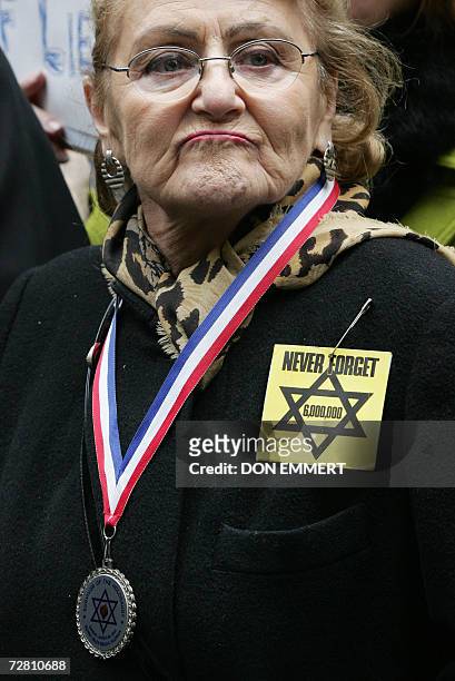 New York, UNITED STATES: Barbara Rosenthal wears a medal with the Jewish Star of David and a remember the Holocaust ribbon during a protest near the...