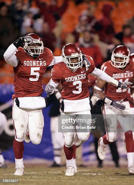 Reggie Smith and Nic Harris of the Oklahoma Sooners celebrate on the field against the Nebraska Cornhuskers during the 2006 Dr. Pepper Big 12...