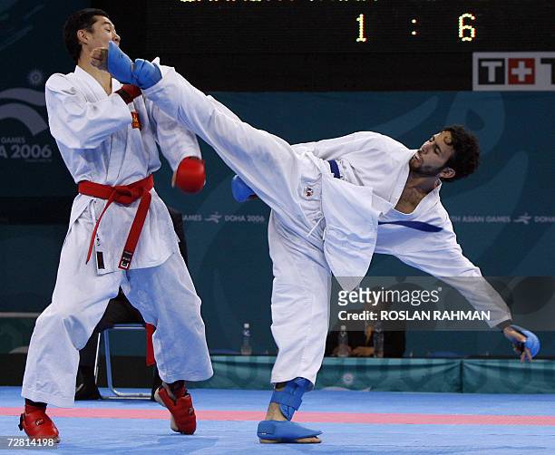 Qatari Magid Adwan fights against Mogolian Enkhj Enkhbat in the men's karate kumite 65kg repechage for bronze during the 15th Asian Games in Doha, 13...