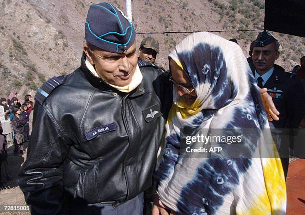 India's Western Air Command Commander in Chief A. K. Singh talks to an earthquake victim at Uroosa in Uri sector some 117 km north of Srinagar and...