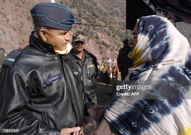 India's Western Air Command Commander in Chief A. K. Singh talks to an earthquake victim at Uroosa in Uri sector some 117 km north of Srinagar and...