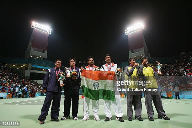 Gold medallists Leander Paes and Mahesh Bhupathi of India pose with silver medallists Sanchai Ratiwatana and Sonchat Ratiwatana of Thailand and...