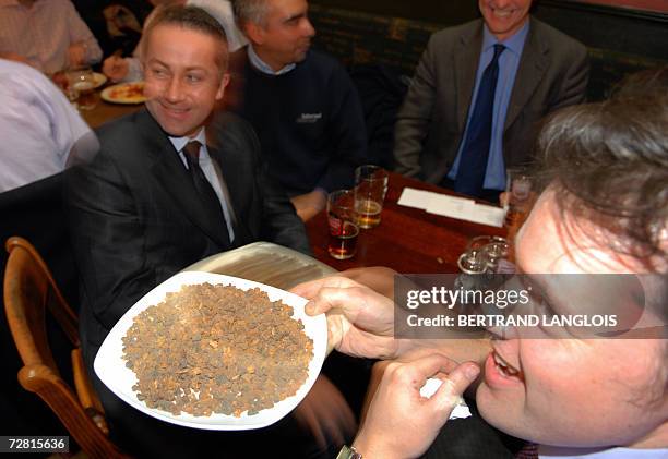 United Kingdom: Christmas drinkers and diners try to identify a plate of myrrh during a challenge organised by members of the British Royal Society...