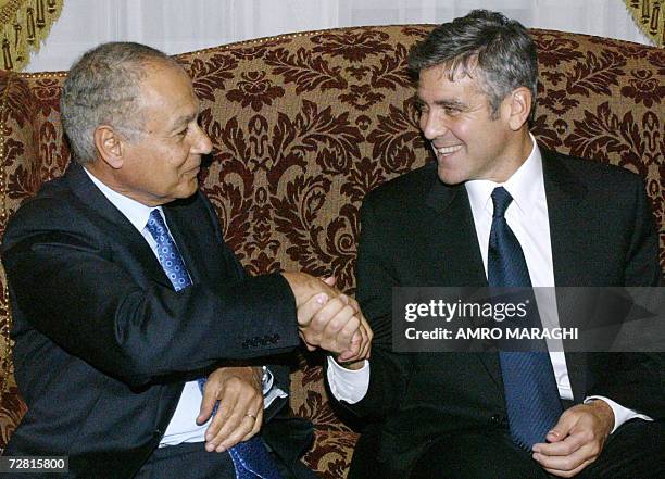 Actor George Clooney shakes hands with Egyptian Foreign Minister Ahmed Abul Gheit at the foreign ministry in Cairo 13 December 2006. The...