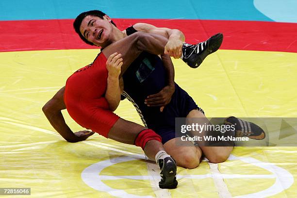 Bauyrzhan Orazgaliyev of Kazakhstan competes with Yogeshwar Dutt of India in the Men's Freestyle 60kg - Bronze Medal Match at the 15th Asian Games...