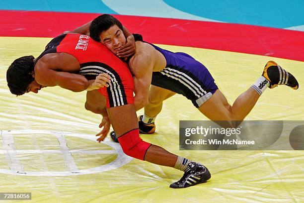 Bauyrzhan Orazgaliyev of Kazakhstan competes with Yogeshwar Dutt of India in the Men's Freestyle 60kg - Bronze Medal Match at the 15th Asian Games...