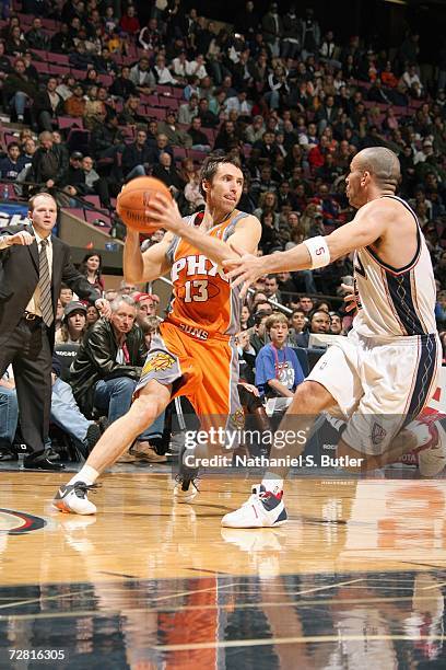 Steve Nash of the Phoenix Suns holds the ball away from Jason Kidd of the New Jersey Nets during the game at Continental Airlines Arena on December...