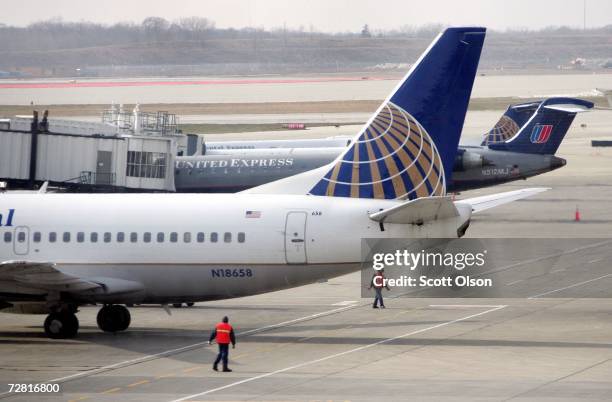 Continental Airlines jet prepares to leave a gate where it was loaded next to a United Airlines jet at O'Hare Airport December 13, 2006 in Chicago,...