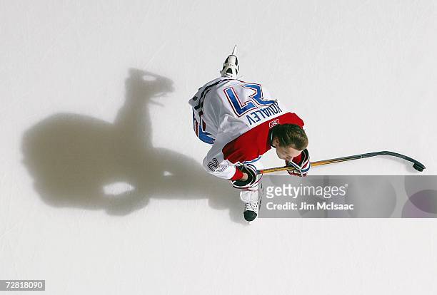 Overhead view of Alex Kovalev of the Montreal Canadiens taking a shot in warm-ups during their NHL game against the New York Islanders on December 7,...