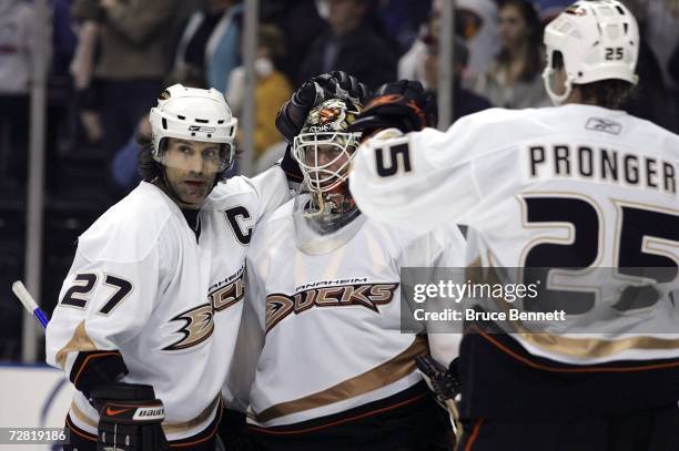 Scott Niedermayer and Chris Pronger congratulate goaltender Jean-Sebastien Giguere all of the Anaheim Ducks and their 2-1 win over the Atlanta...