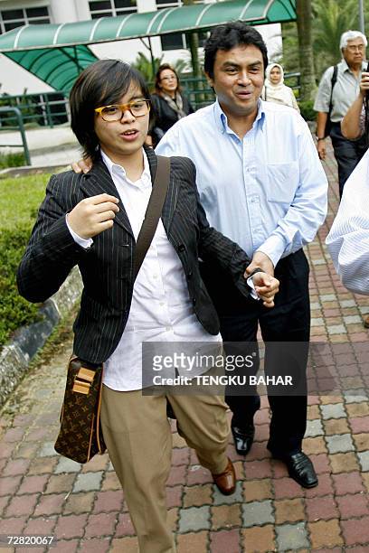 Kuala Lumpur, MALAYSIA: Abdul Razak Baginda , charged in connection with the murder of Mongolian model Altantuya Shaariibuu, is accompanied by his...