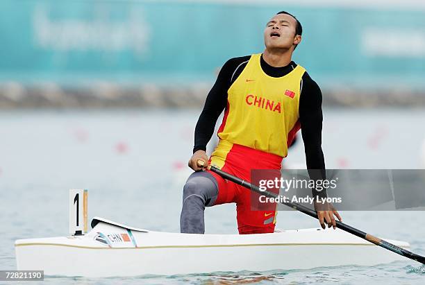 Yang Wenjun of China celebrates crossing the line first in the Canoe Single 500m Men's Final at West Bay Lagoon during the 15th Asian Games December...