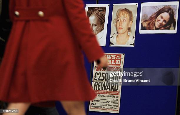 The pictures of the five murdered or missing prostitutes are pinned to a board during a press conference in Suffolk's Police headquarters on December...