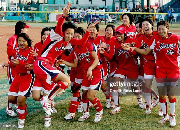 Eri Yamada of Japan celebrates with her team after winning the gold medal in the game against Chinese Taipei at the 15th Asian Games Doha 2006 at the...