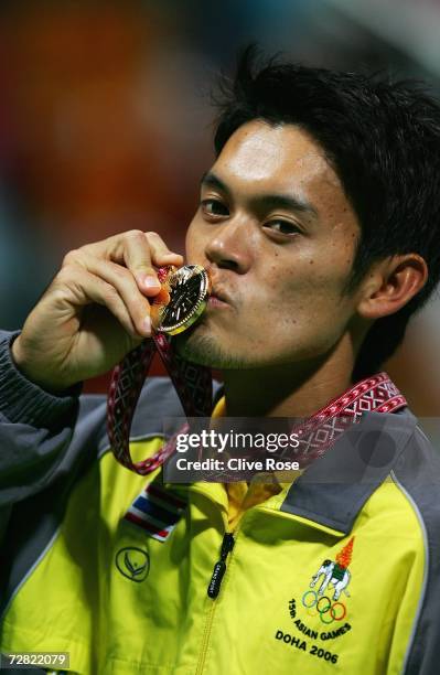 Danai Udomchoke of Thailand poses with the gold medal after the Men's Singles Final against Lee Hyung Taik of Republic of Korea during the 15th Asian...