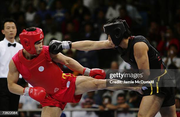 Zhao Guangyong of China in action with Nguyen Duc Trung of Vietnam during the Men's -65kg Sanshou final at the 15th Asian Games Doha 2006 in the...